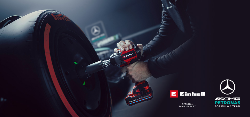 Einhell accu slagschroevendraaier in gebruik op een autowiel, met Mercedes-AMG Petronas Formula One Team-branding en partnerlogo