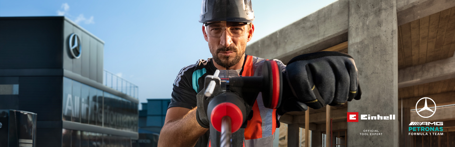 Een monteur in beschermende kleding die met elektrisch gereedschap aan het boren is op een bouwplaats.